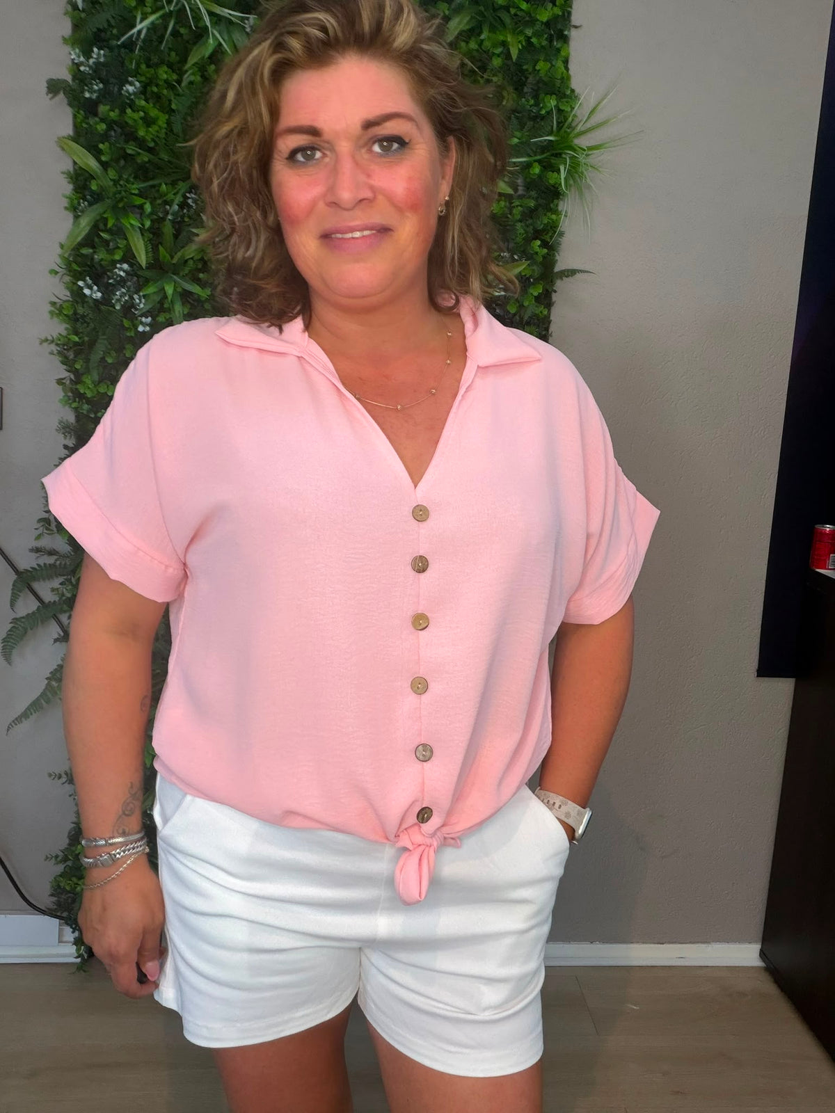 Knoop top Pinky in roze met knoopjes, gedragen met een witte short