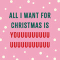 Roze tegeltje met sneeuwstippen en tekst All I want for Christmas is youuuu in groen en rood